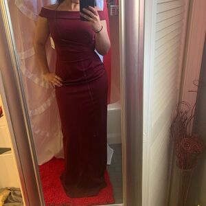 Off shoulder side drape with slit in the back. Formal dress